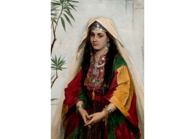 A portrait of a woman as a bride with a red-yellow-green dress, cream veil, and a lot of silver jewelry.