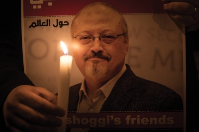 An image of a Saudi Arabian man with a goatee with a candle in front.