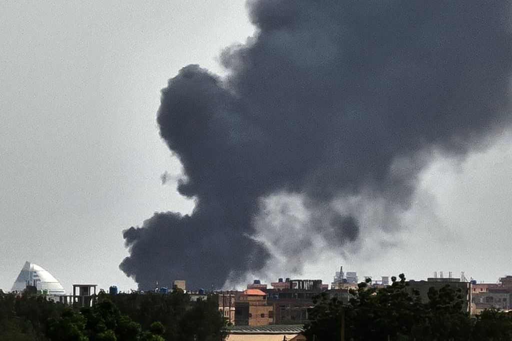 Smoke billows behind buildings from a reported fire in Khartoum, on June 5, 2023, as fighting continues between two warring generals. Multiple ceasefires have been agreed and broken between Sudan's regular army and paramalitary Rapid Support Forces (RSF), and Washington slapped sanctions on the leader of each side last week, blaming both for the "appalling" bloodshed. (Photo by AFP) (Photo by -/AFP via Getty Images)