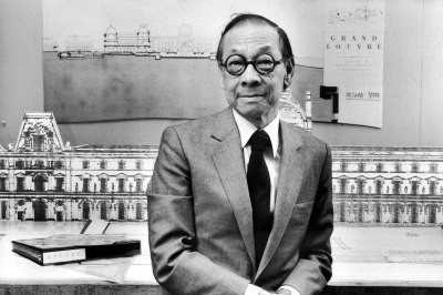 Architect I.M. (Ieoh Ming) Pei in his office, standing in front of drawing of The Louvre.