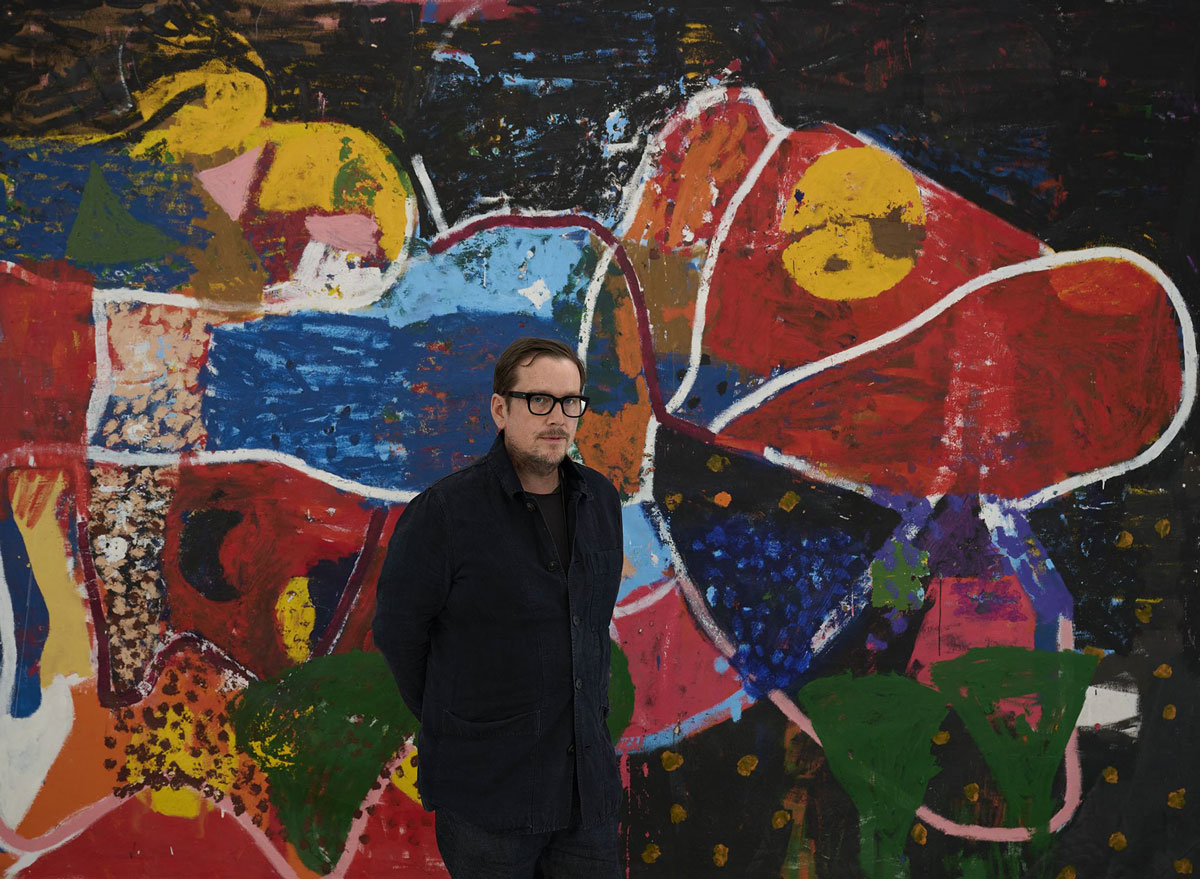 Portrait of Joe Bradley in front of one of his abstract paintings.