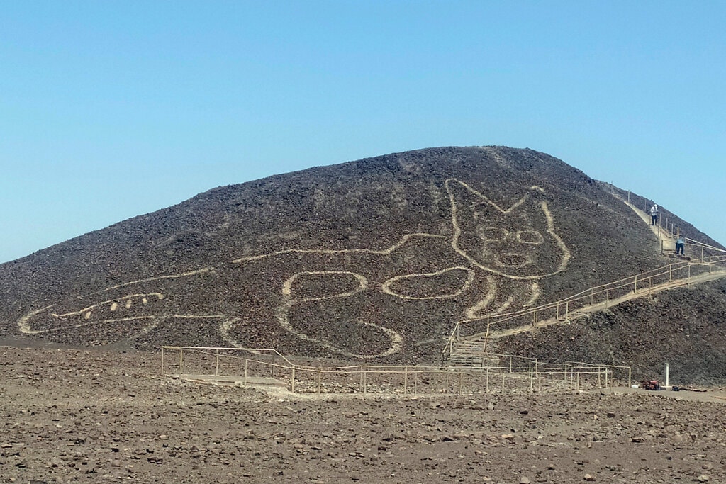 The catlike geoglyph on a hillside in Nazca, Peru.