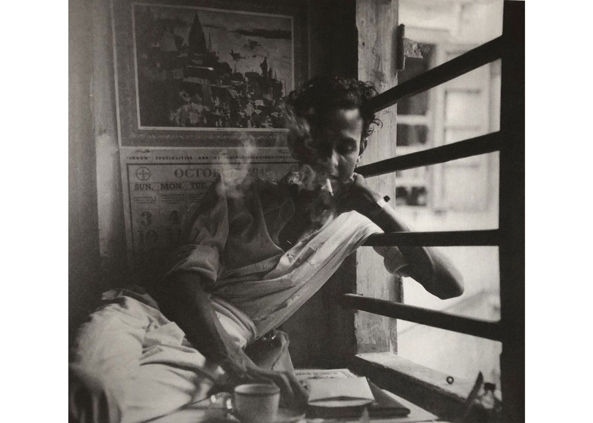 Portrait of a young S.H. Raza smoking in his studio.